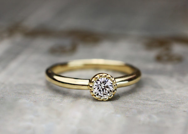 ダイヤモンドをミルグレインで囲ったゴールドの婚約指輪