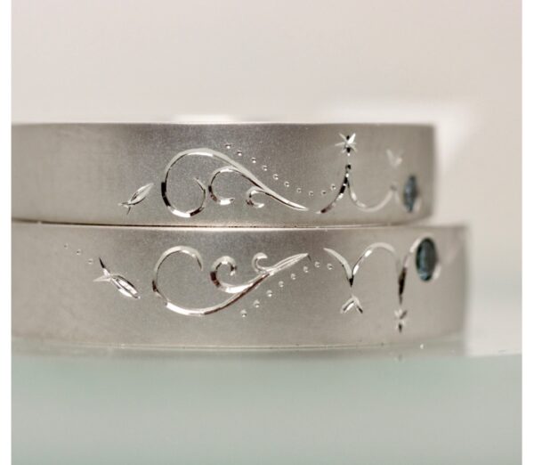 ブルーダイヤを、 それぞれに留めて、波とイルカ模様で ハート模様を完成させる結婚指輪です。